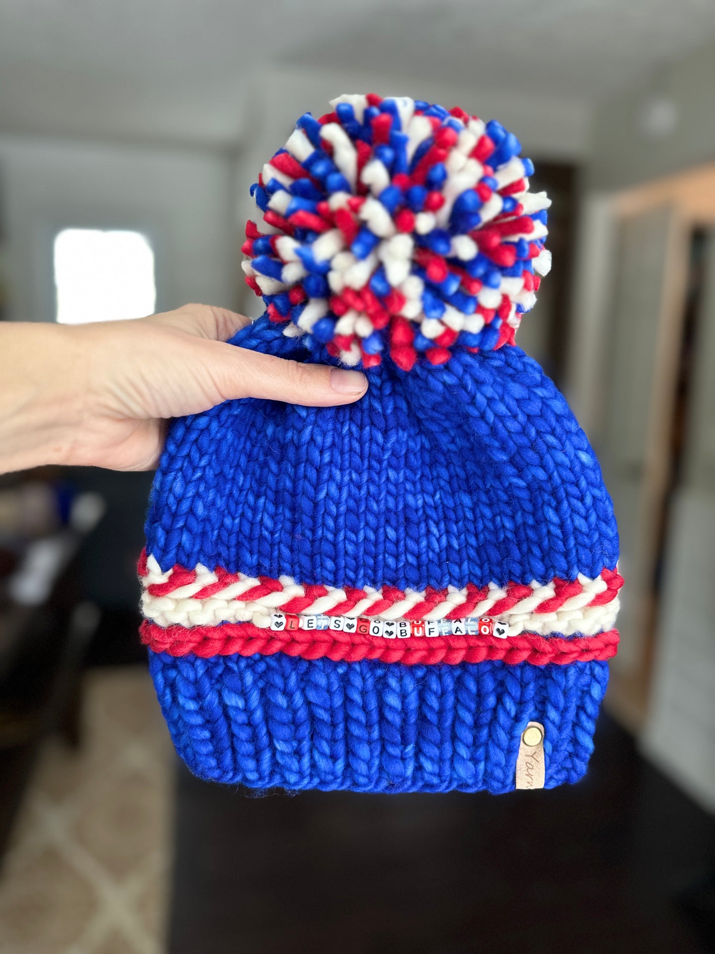 Sports themed merino wool knit hat with merino pom