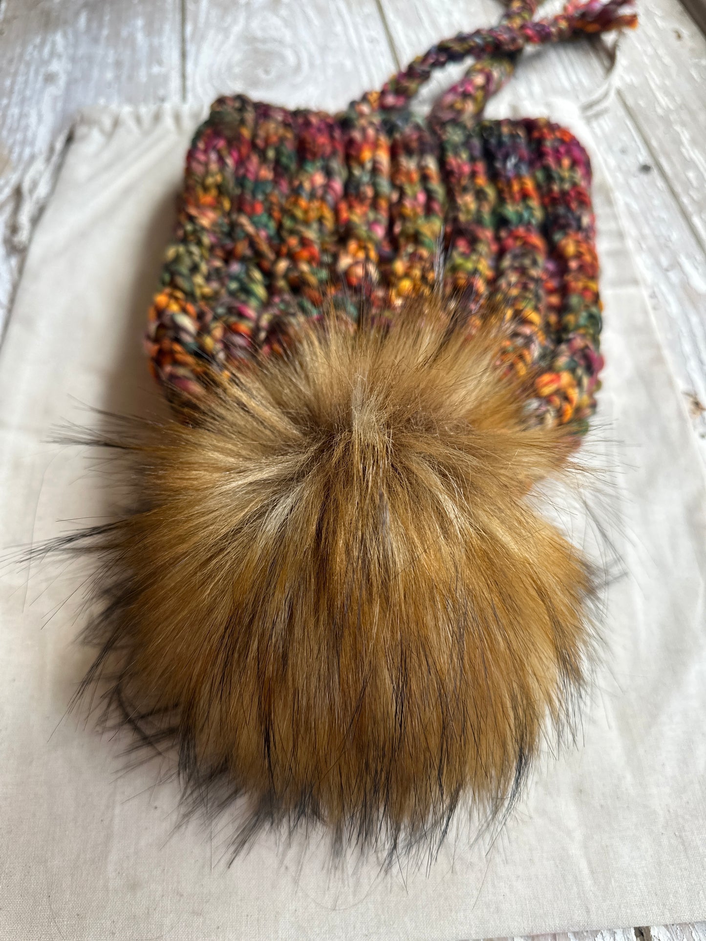 Merino wool split brim knit hat with faux fur pom