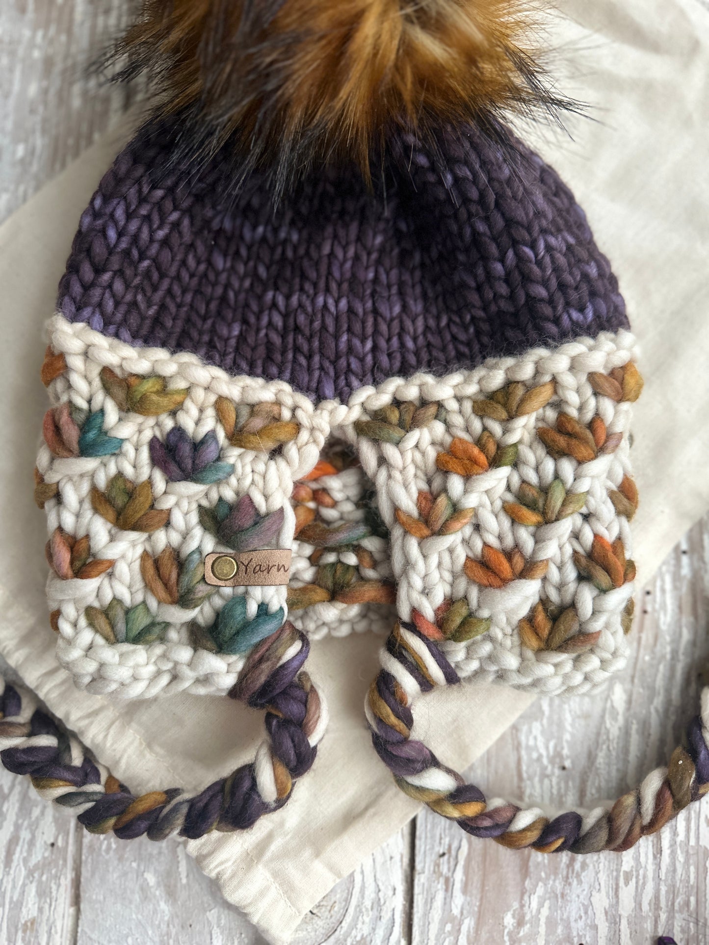 Merino wool knit split brim beanie with faux fur Pom
