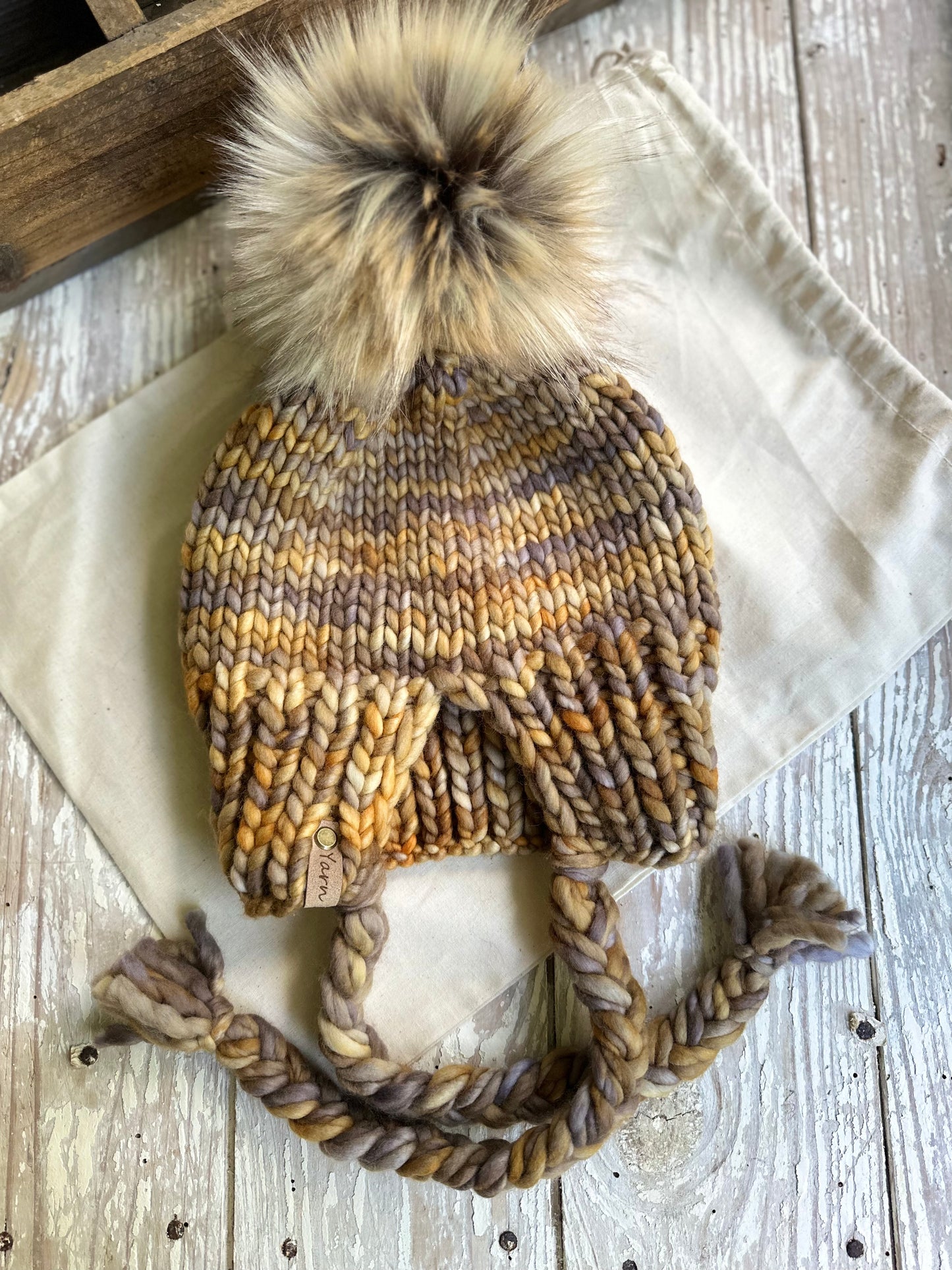 Merino wool split brim beanie with faux fur pom
