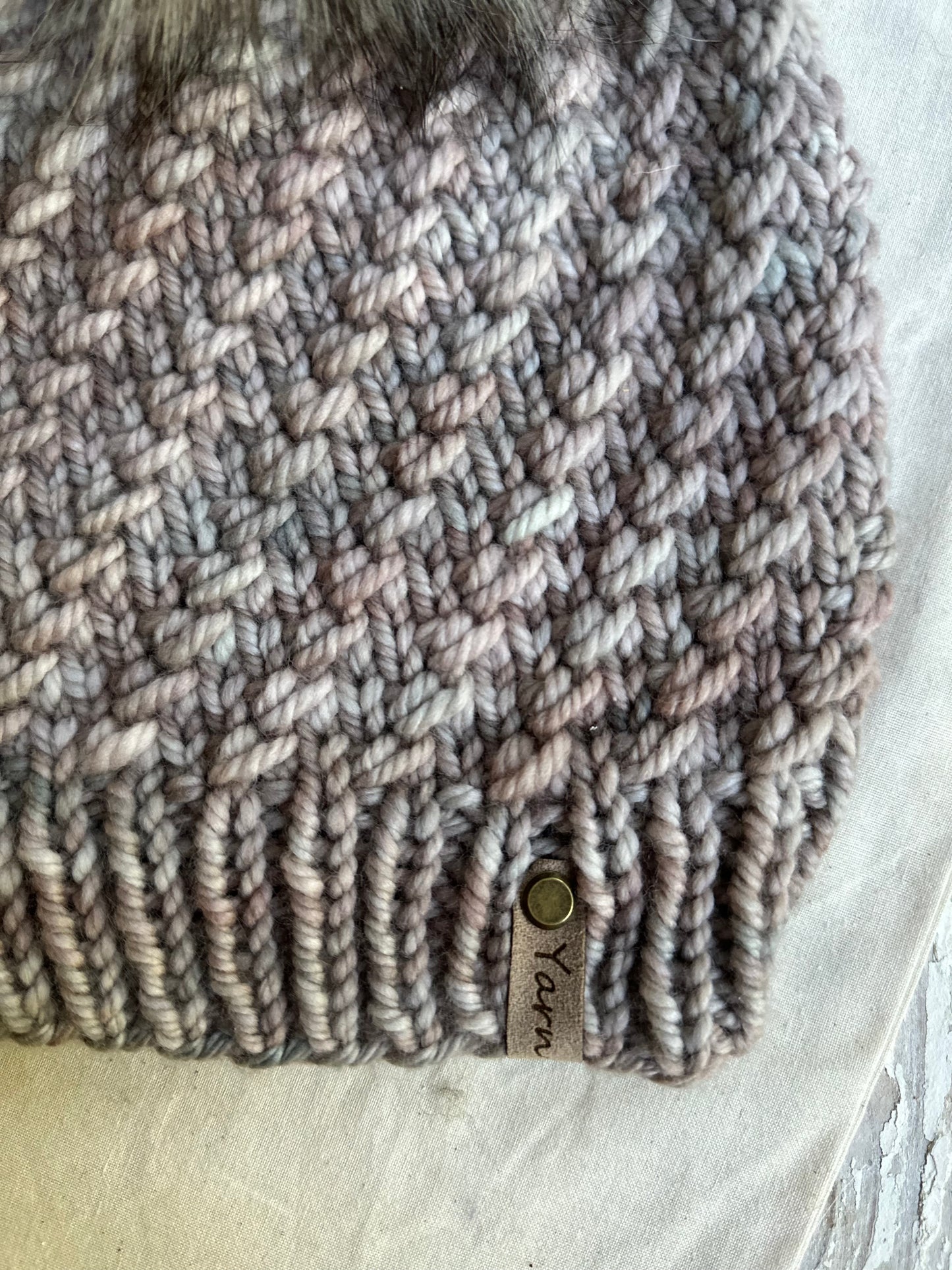 Merino wool knit hat with faux fur pom