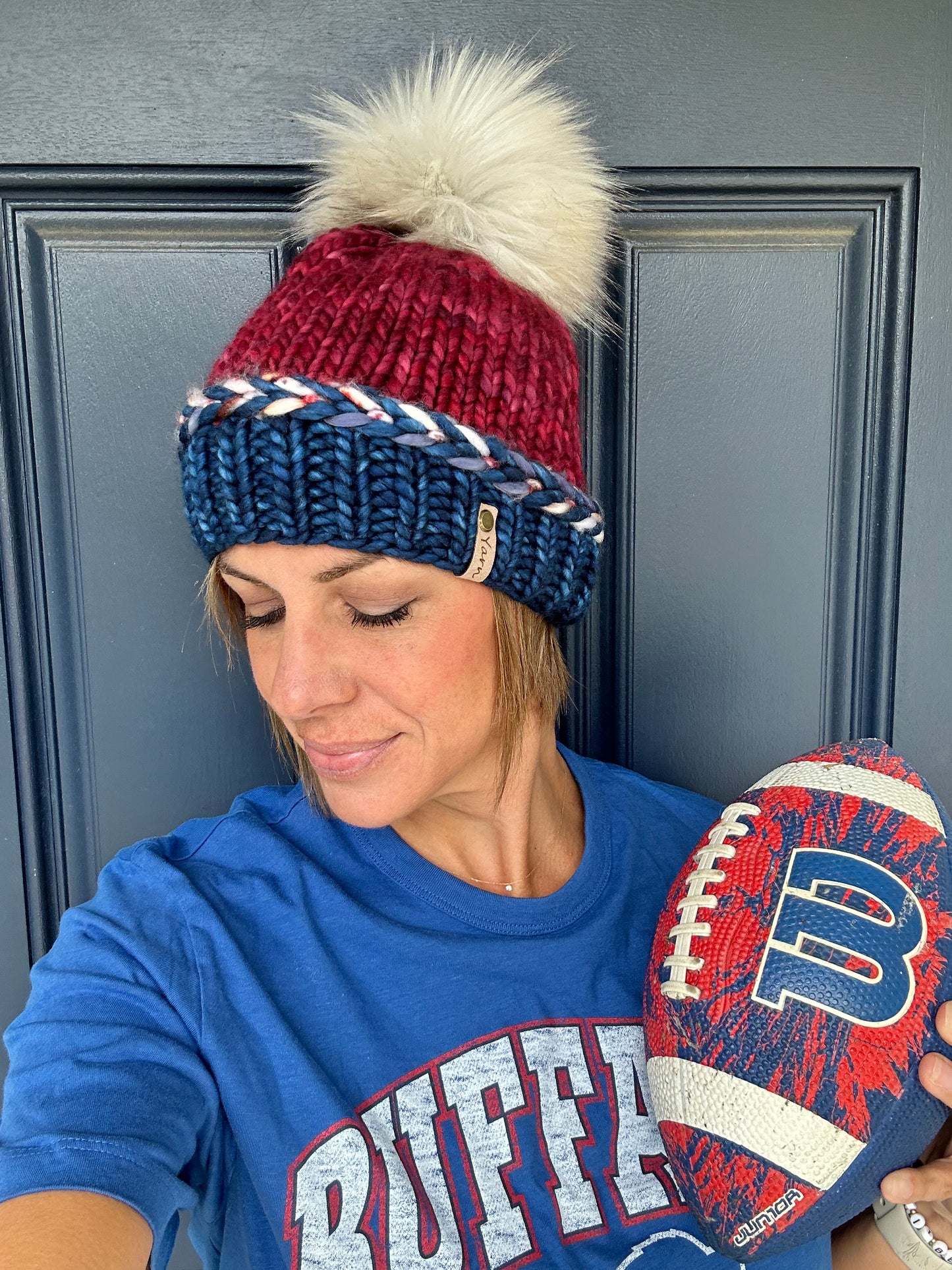 Sports themed Merino wool knit hat with faux fur pom